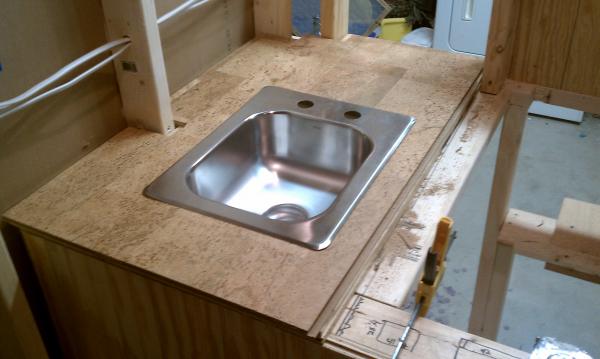 Dryfit of the fixed portion of the lid with cork surface material and sink.