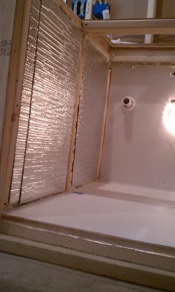 FRP pebble board has been applied to the wall between the bathroom and kegerator.  Plumbing is finished there with a drain for the sink and water supplies.  Reflectix is in place for the front wall of the bar.  Most parts of the bar have, going from outsi