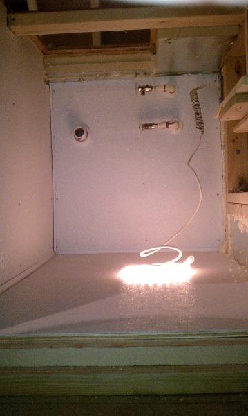 Water supplies and sink drain.  Rope light is plugged into the switched GFI protected outlet inside the bar.