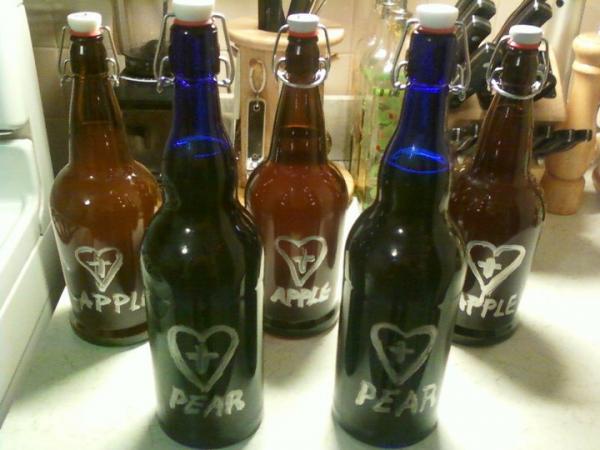 some of my pear and apple ciders in fliptop bottles