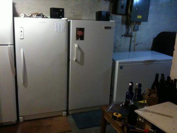 Left to right:hops storage and lagering/aging fridge, 2 upright fermenting freezers, lagering/aging chest freezer.