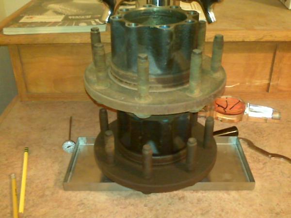 The standard bolt through drain pan fitting wouldnt work, so I glued the drip pan down with silicone adhesive and used my extra f250 hubs to hold it in place.