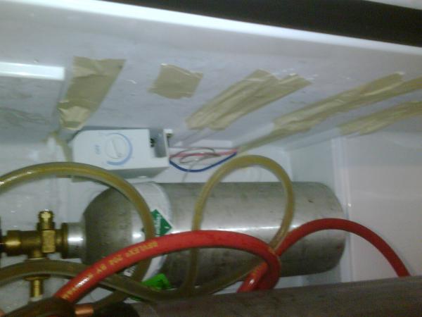 And another picture of the back, and you can also see the side where I had to remove the railings for the shelves in order to fit the 2 cornies. Also, note that I moved the temp controller to the back, and removed the light and cut the plastic out of wher