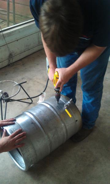 Drilling a hole for a thermometer on what was our only keggle, now it has become our Hot Liquor tank.