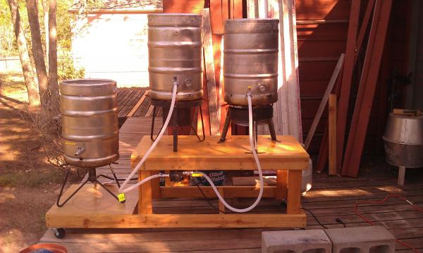 New pic of the system as it is now, and functional.  Notice we had to turn the pump around and build a little shelf for it. I don't know much about pumps, but it did not work the other way around, someone mentioned rotating the head, but this works, so it