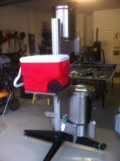 top tier with a burner on top and bottom, cooler platform in middle. March pump and therminator on other side of bottom burner