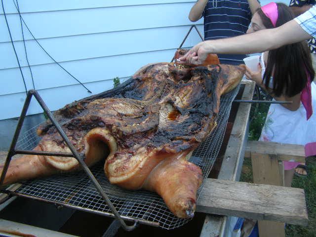 cookedpigliftedupforserving