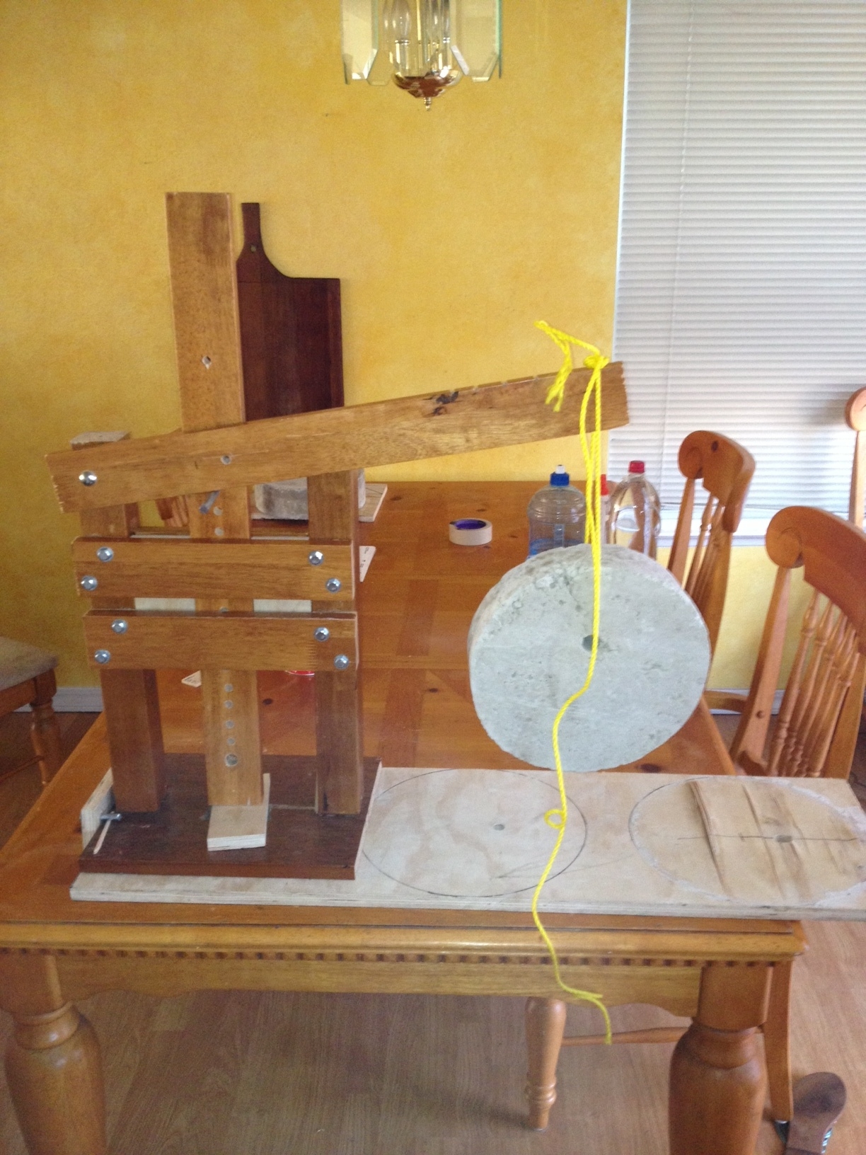 Weight test cheese press with 23 pounds of concrete to check the structural inegrity