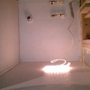 Water supplies and sink drain.  Rope light is plugged into the switched GFI protected outlet inside the bar.