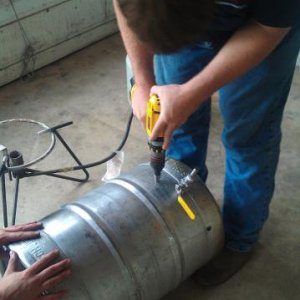 Drilling a hole for a thermometer on what was our only keggle, now it has become our Hot Liquor tank.