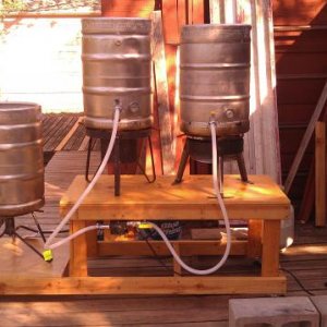 New pic of the system as it is now, and functional.  Notice we had to turn the pump around and build a little shelf for it. I don't know much about pumps, but it did not work the other way around, someone mentioned rotating the head, but this works, so it